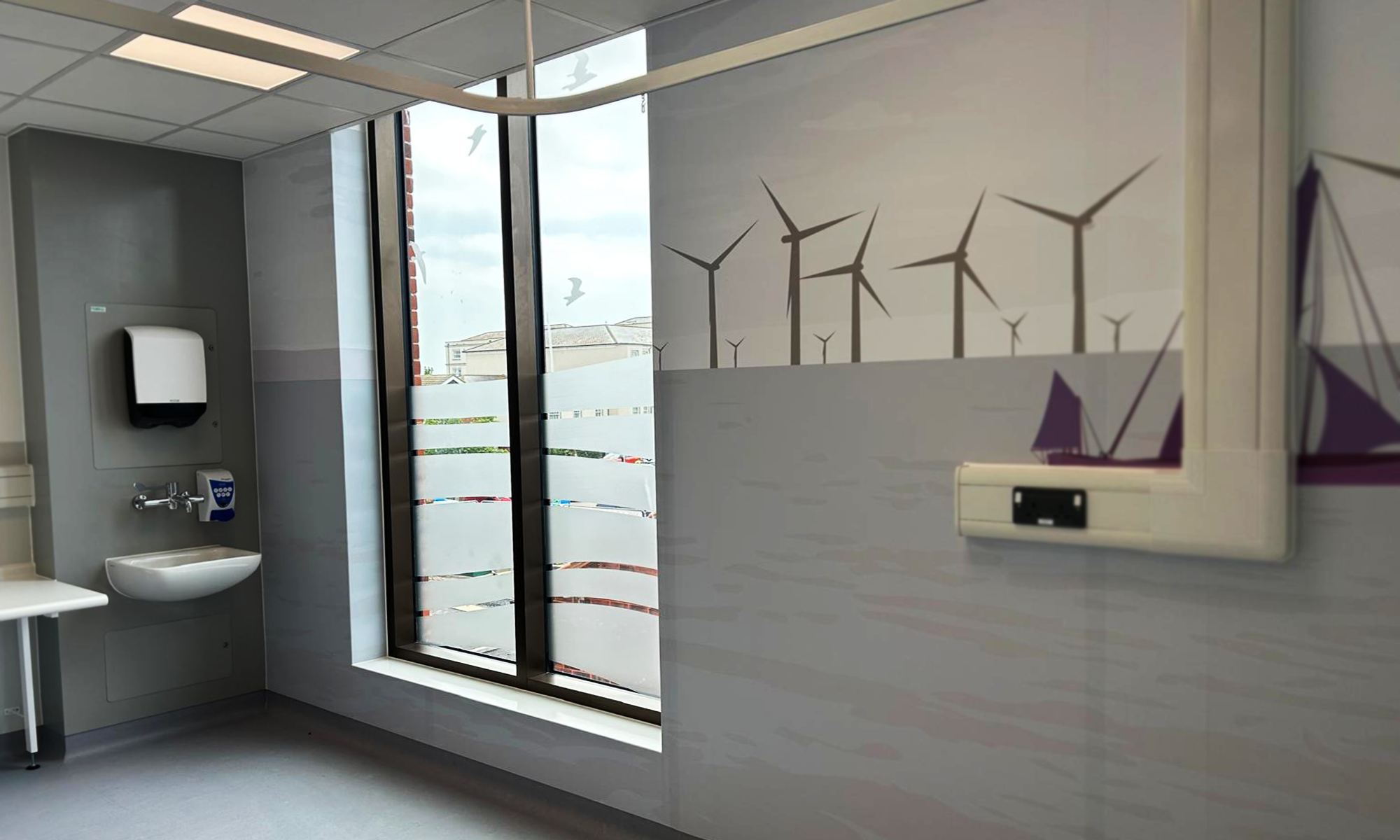 [PLACEHOLDER: confirm location/project] Printed hygienic wall cladding beside a window